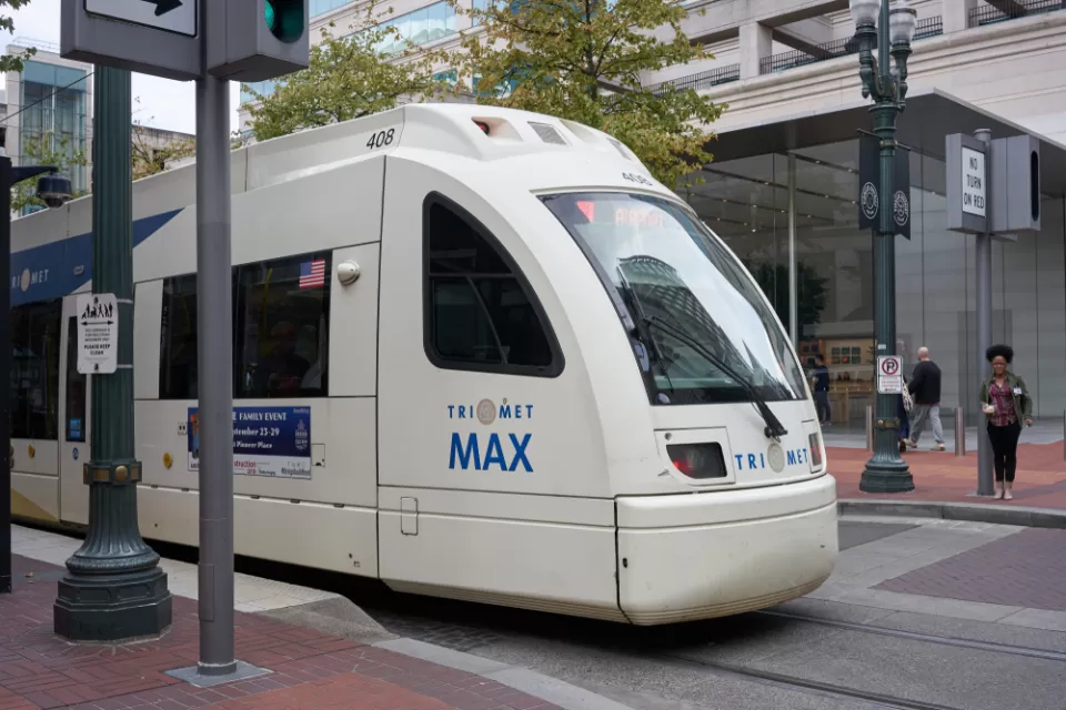 A TriMet MAX Red Line light rail train heading for the Portland International Airport comes to a stop at Pioneer Place in downtown Portland.